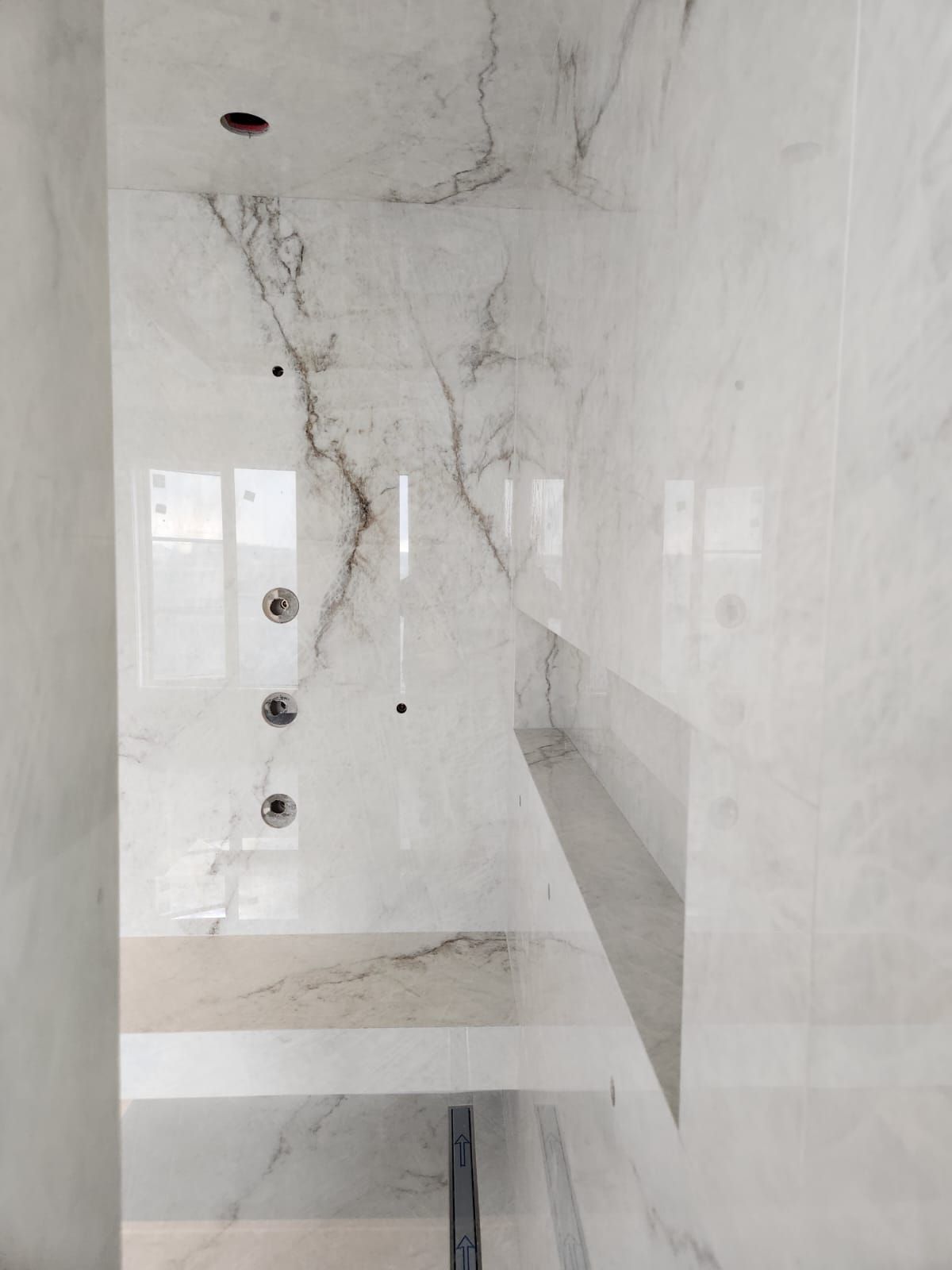 White marble shower wall installation