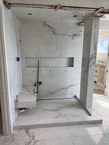 White marble shower with built-in bench